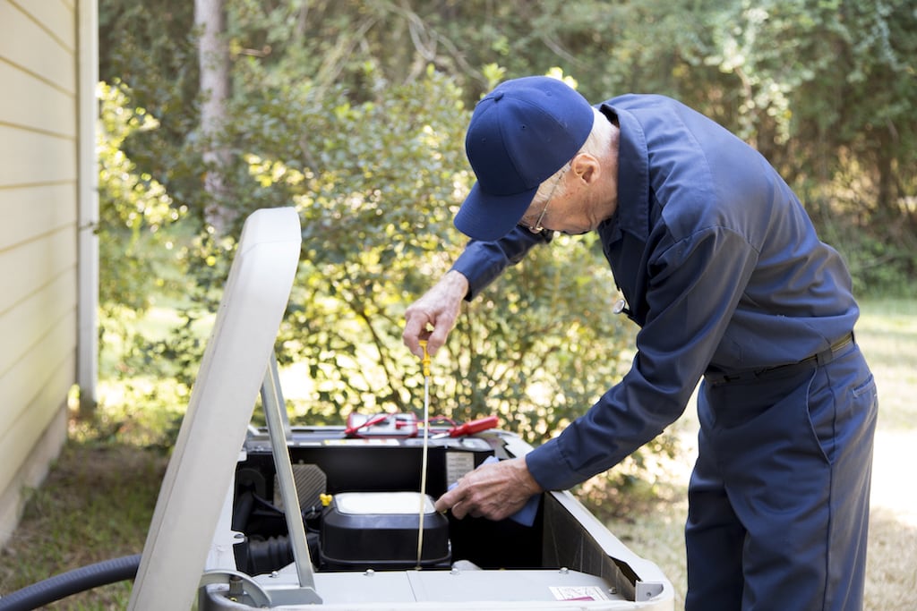 Generator Repair technician working on a home generator.