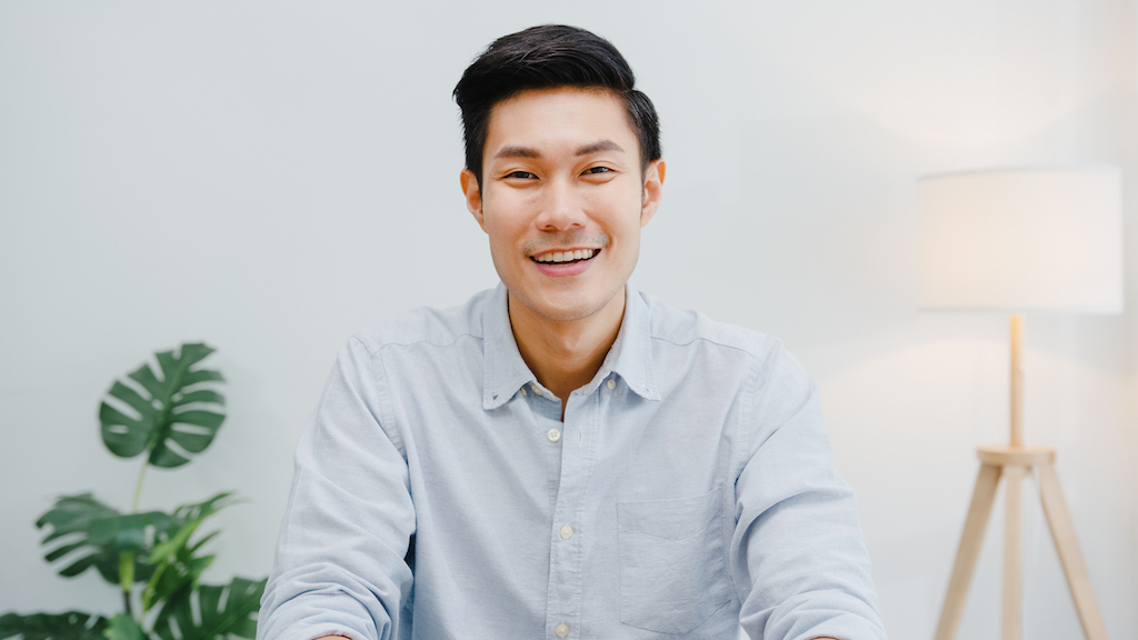 Man in blue button up shirt smiling into camera thanks to Briggs Generators.
