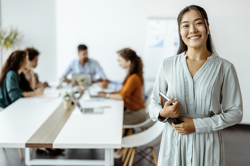 Happy woman running a meeting. Commercial Generator Service.
